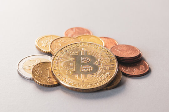 Bitkoin coin on a pile of euro cash