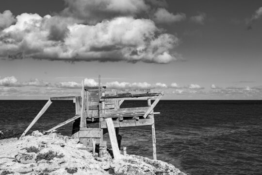 black and white photo of Trabucco, (Trabocco, Trebuchet) overlooking the Adriatic sea, a traditional Italian wooden fishing house on Apulian coast. Costa dei Trabocchi, Puglia (Apulia), Italy, Europe