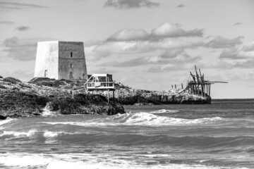 black and white image of Calalunga Tower and Trabucco, (Trabocco, Trebuchet) on Apulian coast, on Adriatic sea. Peschici, Puglia (Apulia), Italy, Europe
