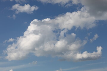 Fototapeta na wymiar White cumulus clouds in a blue sky with a place for text, Concept lettering and advertising,