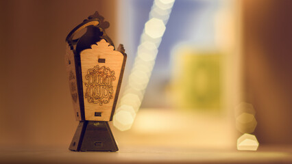 A small wooden Lantern ( Fanous ) of Ramadan with the phrase ramadan kareem written on it in...