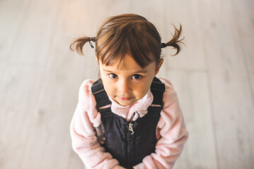 Portrait of a little and beautifull girl with cute pigtails