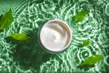 beauty cream and green leaves on clear water