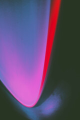 Abstract image of colorful shapes of light against black background