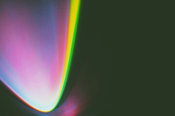 Abstract image of colorful shapes of light against black background