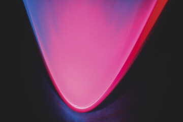 Abstract image of colorful shapes of light against black background