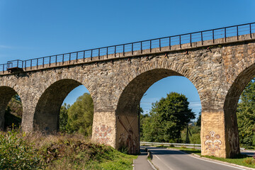 Fototapeta premium Vorokhta, Ukraine – September 24, 2021: A big, old, ancient aqueduct bridge in the mountains