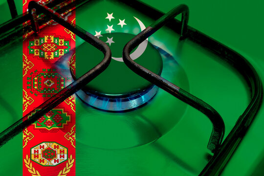 Close up of Household gas burner blue flame, national flag of state Turkmenistan on burner of gas stove, concept of gasification of country, heating in winter, natural resources, natural gas trade