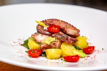 Traditional Spanish octopus salad with potatoes, drizzled with olive oil