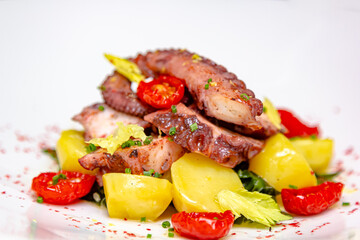 Traditional Spanish octopus salad with potatoes, drizzled with olive oil