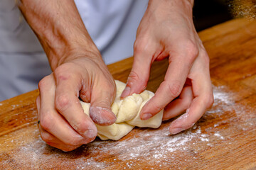 The cook prepares dough from flour and eggs