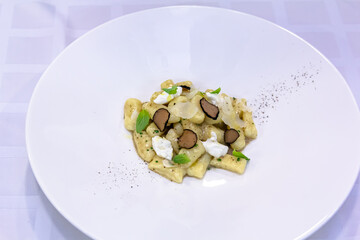 The Italian dish gnocchi with truffle is on the plate