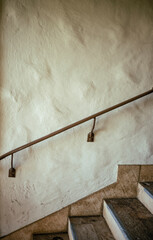 Red Tile Stairs with Railing and an Adobe Wall Background.