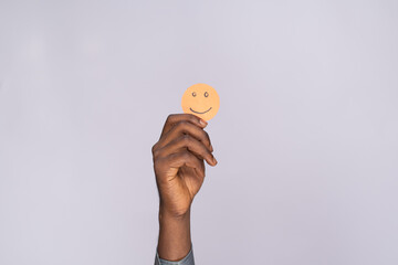 black man holding cardboard cutout smiling emoji face