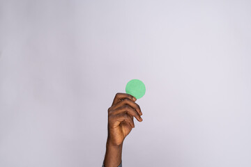 black man holding blank small cardboard circle for emoji face