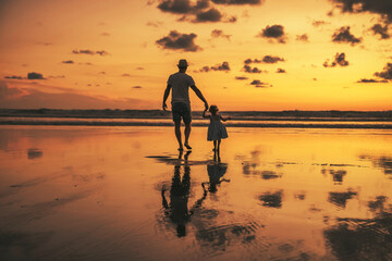 happy family at the beach a father and baby daughter having fun at sunset