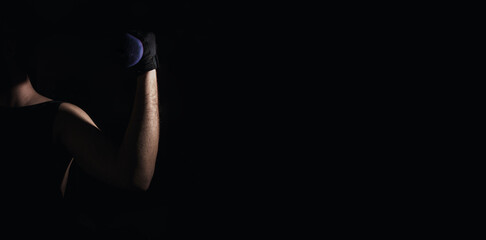 Young man practicing muscle and strength exercises with dumbbells. High intensity fitness. Copy space. Selective focus.