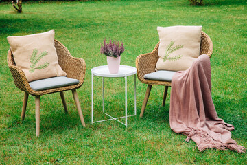Modern garden chairs and flowers . Garden joy in summer. Relax in the garden and enjoy the...
