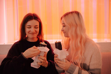 LGBT Lesbian couple eat sushi rolls in asian cafe