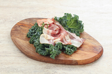 Raw pork bacon over board