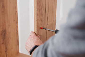 Furniture fasteners are screwed with a screwdriver