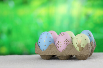 the concept of Easter, holidays and traditions - a row of painted eggs on a background of green grass