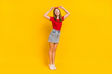 Fototapeta na wymiar Full size photo of cute charming girl dance fooling around fix adjust retro headband isolated on yellow color background