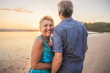 Senior Couple Enjoying Beautiful Sunset on the Beach