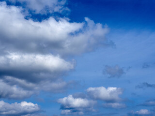Fluffy white clouds on a vibrant blue sky