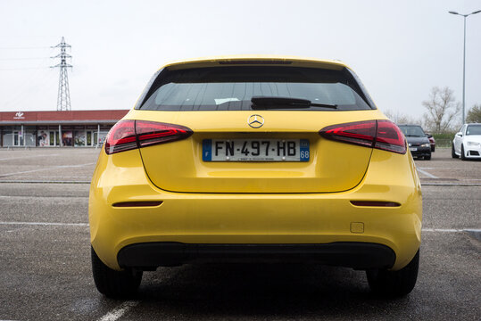 Lutterbach - France - 3 April 2022 - Rear view of yellow mercedes A45 parked in the street