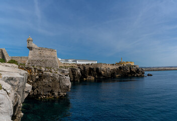 Fototapeta na wymiar view of the jagged rocky coast and historic fortress in the center of Peniche
