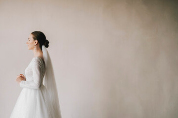 Incredible bride in an elegant wedding dress in the European style. Boudoir dress in the interior...