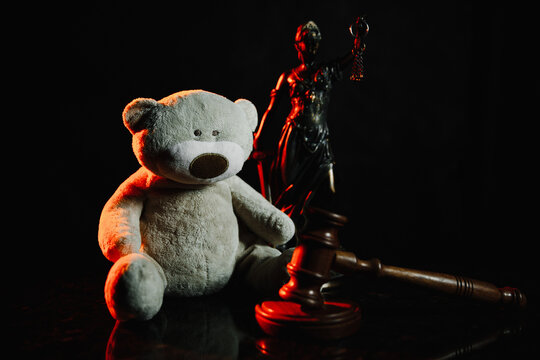 Judge Gavel, Figure Of Lady Justice And Teddy Bear In A Court Room. Divorce, Alimoney And Protection Children Concept