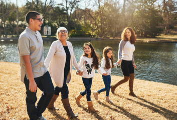 We make sure to spend time together. Shot of a happy multigenerational family spending time together outdoors.