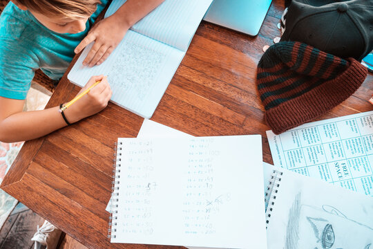 Overhead view of boy doing homework at table