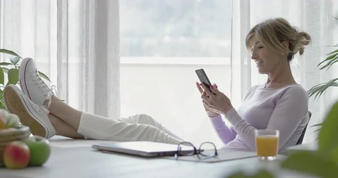 Woman relaxing at home and social networking