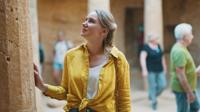 Woman is on an excursion with a tourist group.