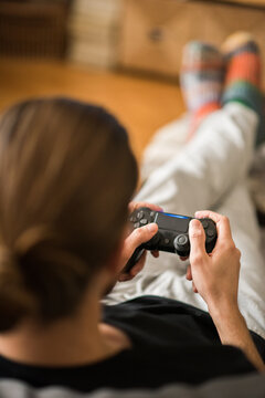 Rear view of man playing video game at home