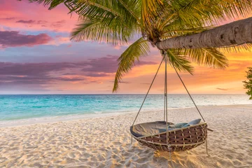  Tropical sunset beach and sky background as exotic summer landscape with beach swing or hammock and white sand and calm sea beach banner. Paradise island beach vacation or summer holiday destination  © icemanphotos
