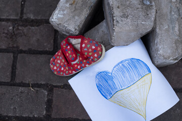 children's shoes and the flag of Ukraine, the warthe war in Ukraine.