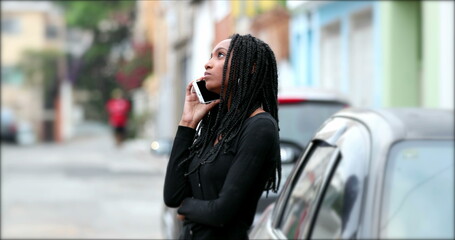 Black teen making a call outside with cellphone