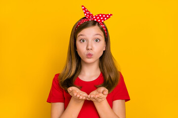 Portrait of adorable kind teenager little girl send you appreciation kiss wear isolated on yellow color background