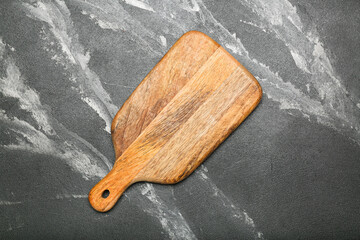 Cutting board on stone kitchen table. top view