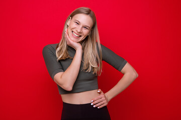 Portrait of a sporty young woman on a red background