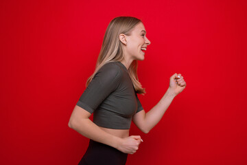 Portrait of a sporty young woman on a red background