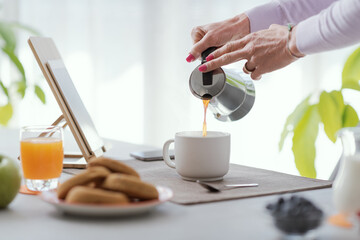 Woman having breakfast at home