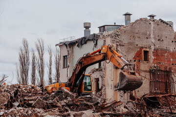 Excavator on demolition site. Process of demolition of old industrial building