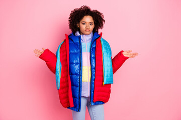 Photo of young pretty girl wear many jackets shrug shoulders puzzled unsure dislike outfit isolated...