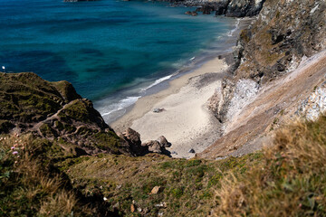 Cornwall coast with steep cliffs, beach and clear water in England, United Kingdom, beautiful hiking and biking trails for tourism and travel