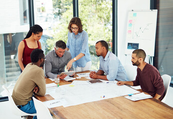 Brainstorming is easy if you have the right tool. Cropped shot of a group of architects in the...